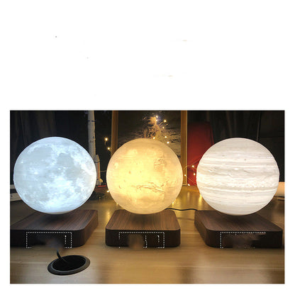 three different color unique cool moon lamps next to each other in a desk