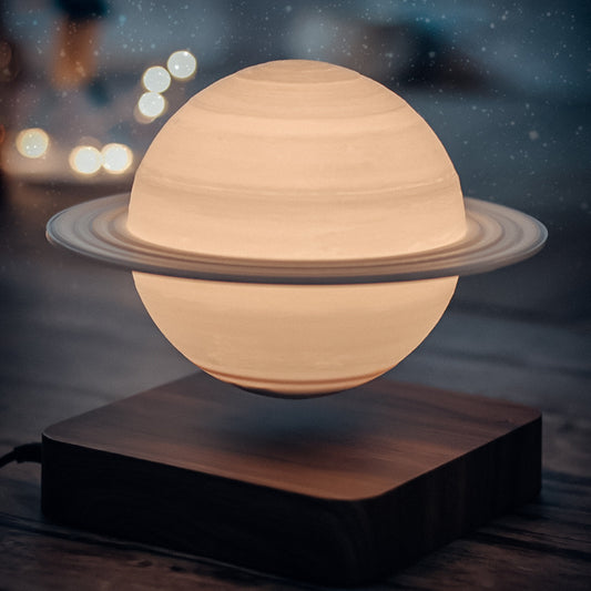 saturn looking cool lamp levitating over a wooden base